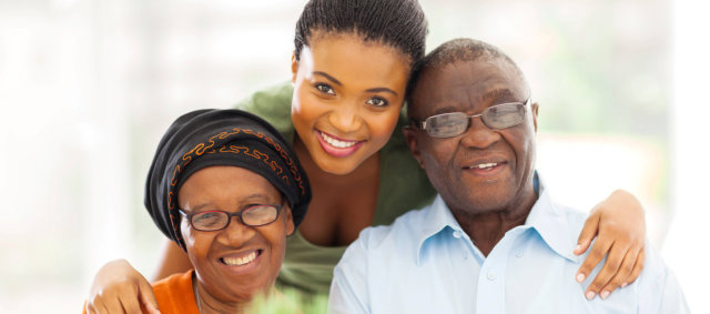 caregiver and senior couple smiling